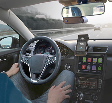 Photo of a person using an automated vehicle smartphone application to drive their car